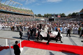 Pope Francis greets people as he arrives to celebrate a mass at Commonwealth Stadium during his visit to Edmonton, Alberta, Canada July 26, 2022.