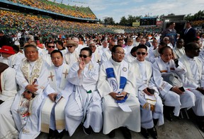 Priests wait for the start of a mass led by Pope Francis at Commonwealth Stadium during his visit to Edmonton, Alberta, Canada July 26, 2022.