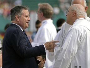 Jason Kenney (left, Premier of Alberta) speaks with members of the clergy prior to an outdoor mass delivered by Pope Francis at Commonwealth Stadium in Edmonton, Canada on Tuesday July 26, 2022.