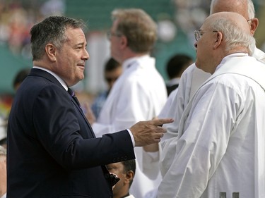 Jason Kenney (left, Premier of Alberta) speaks with members of the clergy prior to an outdoor mass delivered by Pope Francis at Commonwealth Stadium in Edmonton, Canada on Tuesday July 26, 2022.