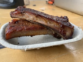 The dry rubbed St. Louis ribs from Smokehouse BBQ (four tickets), reviewed on July 21, 2022, at the 2022 Taste of Edmonton festival are cooked to perfection, have great texture and are neat, but no one would complain if they made more of a mess.