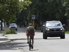 A cyclist makes their way through Edmonton's Ritchie Neighbourhood, Tuesday July 19, 2022. The City is trying to increase awareness of Edmonton's Safe Passing Distance Bylaw and how to pass people cycling and scootering safely on the street.