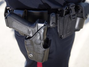 A file photo of an EPS officer wearing his handgun. An officer who lied about a piece of equipment used during a timed shooting event has been docked $35,000 and ordered to participate in a new "off ramp" program, according to a recent disciplinary decision.