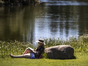 Chelsea Depape enjoys a warm afternoon reading a book at Hawrelak Park in Edmonton Alberta, July 9, 2022.