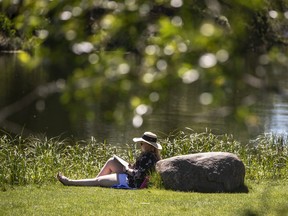 Chelsea Depape takes advantage of a warm afternoon to read a book at Hawrelak Park in Edmonton Alberta, July 9, 2022. Jason Franson for Postmedia
