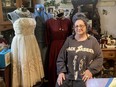 Costume designer Leona Brausen poses with dresses from some of her favourite Fringe shows through the years, including What Gives? and The Glittering Heart.