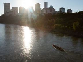 Members of the Edmonton Dragon Boat Racing Club practice on the North Saskatchewan River near the Tawatinâ Bridge on a summer evening in Edmonton, on Monday, Aug. 8, 2022.