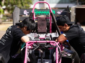 Binghan Ye (left) and Shayne Gambhir, work on the most powerful UAlberta Formula Racing Team race car in the team's history, UA-22, which was completely designed, manufactured and marketed by under-one-year university students at the University of Alberta in Edmonton on Sunday, August 28, 2022. The team's website is at www.ualbertafsae.com.