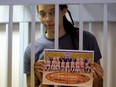 U.S. basketball player Brittney Griner, who was detained at Moscow's Sheremetyevo airport and later charged with illegal possession of cannabis, stands inside a defendants' cage before a court hearing in Khimki outside Moscow, Russia August 4, 2022.