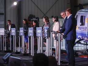 Candidates, left to right, Todd Loewen, Danielle Smith, Rajan Sawhney, Rebecca Schulz, Leela Aheer, Travis Toews, and Brian Jean, attend the United Conservative Party of Alberta leadership candidate's debate in Medicine Hat, Alta., Wednesday, July 27, 2022. The party said its membership had doubled since June.