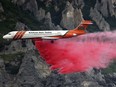 An Erickson Aero Tanker drops fire retardant over a wildfire in Springville on Aug. 1, 2022.