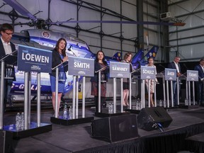 Candidates, left to right, Todd Loewen, Danielle Smith, Rajan Sawhney, Rebecca Schulz, Leela Aheer, Travis Toews, and Brian Jean, attend the United Conservative Party of Alberta leadership candidate's debate in Medicine Hat, Alta., Wednesday, July 27, 2022.
