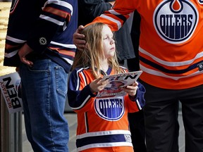 Miranda Gates, 9, pays her respects at a farewell funeral procession for Ben Stelter, the 6-year-old Edmonton Oilers hockey fan who was befriended by the team, was held outside Rogers Place in Edmonton on Friday August 19, 2022. Ben died of brain cancer.