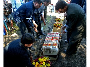 In a special ceremony, on Aug. 28, 2005, eight caskets containing human remains from early Indigenous people are returned to their original resting place in the burial grounds in the Rossdale area of the North Saskatchewan River valley.
