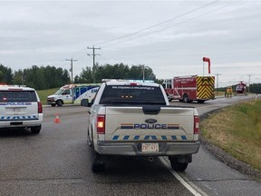 RCMP are seen Wednesday, Aug. 3, 2022 at Highway 16A and Range Road 20 where a collision between a truck and sedan left a 22-year-old woman dead.