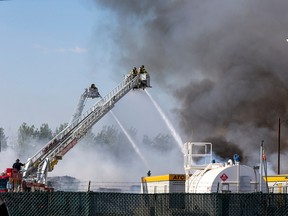 Firefightesr work to control the fire at GFL Environmental Inc. transfer station and recycle facility on Thursday, Aug. 25, 2022.