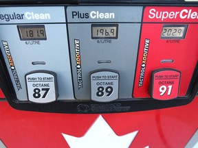 Prices are shown at a gas station in the Woodbine neighbourhood of southwest Calgary in mid-July. They've since dropped across the city.