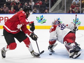 Canada's Mason McTavish (23) scores a goal against Czechia's goalie Tomas Suchanek (30) during second period IIHF World Junior Hockey Championship action in Edmonton on Saturday, Aug. 13, 2022.