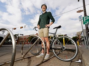 Stephen Raitz (board member, Paths For People) on his bicycle beside the curb on Whyte Avenue in Edmonton on August 21, 2022. A city council committee is reviewing a long-term plan on how curb-side spaces in Edmonton are used to encourage people to use public transit or alternative modes of transportation instead of motor vehicles.