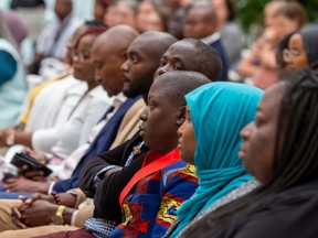 People listen to Mayor Amarjeet Sohi as he speaks at a ceremony where the City of Edmonton renewed its support for the United Nations International Declaration on People of African Descent and announced new actions to fight anti-black racism in Edmonton on Monday, August 29, 2022.
