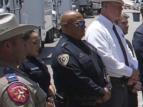 Uvalde School Police Chief Pete Arredondo, third from left, stands during a news conference outside of the Robb Elementary school on May 26, 2022, in Uvalde, Texas.