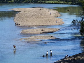People cool off in the North Saskatchewan River along Accidental Beach as the temperature is expected to get to 30 C on Tuesday, Aug. 30, 2022 in Edmonton.