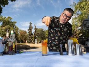 Erick Rosende with Ultimate Bartending School demonstrates a Caribbean cocktail with flair and flowers during a preview for the Cocktail and Jerk Festival, which runs Sept 3-4 at Dr. Wilbert McIntyre Park.