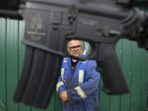 Operation Valour organizer Scott Collacutt is framed by an airsoft rifle, north of Edmonton Monday Sept. 16, 2019. The war game's 10th anniversary saw record ticket sales in the lead up to an an event Saturday, Sept. 17, 2022.