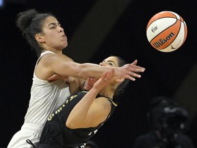 Phoenix Mercury guard Kia Nurse (0) is called for a loose ball foul against Las Vegas Aces guard Kelsey Plum (10) during the second half of Game 2 in the semifinals of the WNBA playoffs Thursday, Sept. 30, 2021, in Las Vegas.
