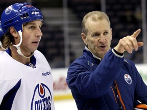 Edmonton Oilers head coach Ralph Krueger gives some instructions to Ryan Smyth in this training camp file photo at Rexall Place in Edmonton on Jan. 17, 2013.