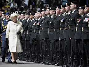 Queen Elizabeth II reviews the honour guard during the official departure ceremony at the Saddledome Wednesday, May 25, 2005 in Calgary.