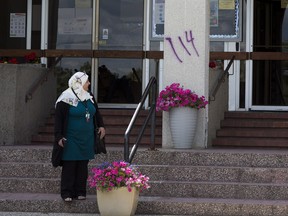 A photo of racist spray paint graffiti found on the Al Rashid Mosque as a hate crime on July 14, 2020, in Edmonton.  Pillars on the mosque’s front steps were vandalized in purple spray paint. The symbol "114" used by white supremacist hate groups was painted on the pillars flanking the main entrance. Alberta's government recently announced funding for a study to understand the growing problem of hate crime in Alberta.