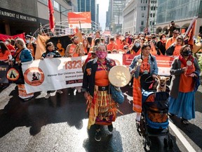 People participate in the "Every Child Matters" march to mark the first National Day for Truth and Reconciliation in Montreal on September 30, 2021.