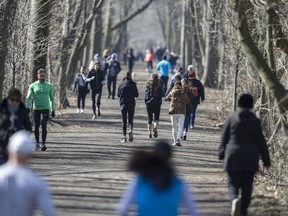 Joggers, walkers and cyclists use The Belt Line for exercise in Toronto while social distancing due to the Covid 19 virus, Friday March 27, 2020.