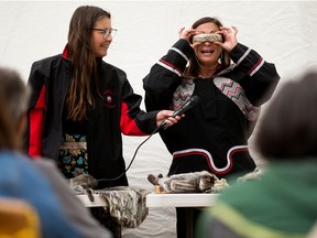Goota Desmarias (right) demonstrates a pair of ilgaak or iggaak (snow goggles) during a presentation on Inuit culture and heritage at the Edmonton Aboriginal Seniors Centre, 10107 134 Ave., Wednesday Sept. 7, 2022. Photo By David Bloom