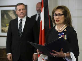 Premier Jason Kenney looks on as Lt.-Gov. Salma Lakhani reads the accession proclamation announcing the death of Queen Elizabeth II and the accession of His Majesty King Charles III, during a ceremony at Government House in Edmonton, Thursday Sept. 15, 2022.