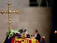 A view of Queen Elizabeth's coffin, draped in the Royal Standard, with the Imperial State Crown and flowers on top, following her death, during her lying-in-state at Westminster Hall, in London, Britain, September 18, 2022. REUTERS/Sarah Meyssonnier/Pool