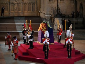 The King's Body Guards of the Honourable Corps of Gentlemen at Arms, the Life Guards, the Blues and Royals and Yeomen of the Guard, stand guard around the coffin of Queen Elizabeth II.