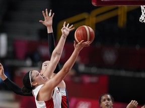 Canada's Natalie Achonwa (11), front, shoots ahead of South Korea's Ji Su Park (19) during women's basketball preliminary round game at the 2020 Summer Olympics, Thursday, July 29, 2021, in Saitama, Japan.