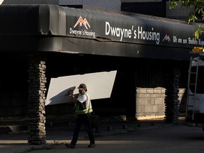 City crews work to board up the former Dwayne's Home building, 10209 100 Ave., Wednesday Sept. 14, 2022, after an early morning fire.