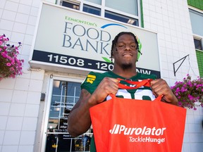 Edmonton Elks player Kony Ealy, part of this year's Purolator Tackle Hunger team ambassadors, lends a hand during a visit to Edmonton's Food Bank on Thursday, Sept. 22, 2022.