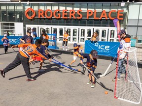 A groups of children play street hockey during Edmonton Oilers Fan Day taking place at the  	Ice District plaza on Saturday, Sept. 24, 2022 in Edmonton. Greg Southam-Postmedia
