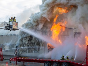 Firefighters battle a structure blaze at 50 Street near 96 Avenue on Monday, Sept. 12, 2022.