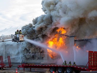 Firefighters put water on a structure fire on 50th Street near 96 Avenue on Monday, Sept. 12, 2022, in Edmonton.   The building has been vacant for quite a while and was totally destroyed by the fire.