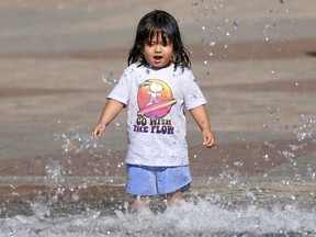 Katrina Loewen Nguyen, 2, cools her heels in the water fountain in front of Edmonton City Hall on Friday September 2, 2022, as temperatures climbed to 32 C degrees. A heat warning is in effect for the region and temperatures are expected to soar to 34 C degrees on Saturday.