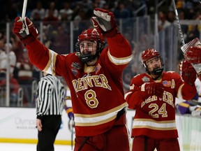 Denver forward Carter Savoie (8) celebrates a goal against Minnesota State during the third period of the 2022 Frozen Four college ice hockey national championship game at TD Garden on April 9, 2022.