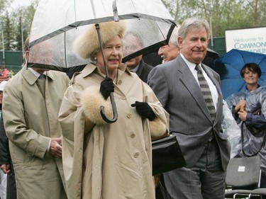 May 23, 2005. Queen Elizabeth II walks with Alberta premier Ralph Klein after her visit to Commonwealth Stadium on a raining day. The Queen was in Alberta to help celebrate Alberta's 100th anniversary.