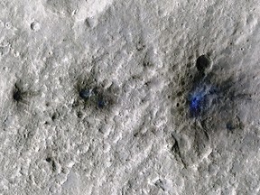 This undated photo released by NASA shows craters that were formed by a Sept. 5, 2021, meteoroid impact on Mars, the first to be detected by NASA's InSight. Taken by NASA's Mars Reconnaissance Orbiter, this enhanced-color image highlights the dust and soil disturbed by the impact in blue in order to make details more visible to the human eye. NASA lander on Mars has captured the vibrations and sounds of four meteorites striking the planet's surface. Scientists reported Monday, Sept. 19, 2022, that Mars InSight detected seismic and acoustic waves from a series of impacts in 2020 and 2021.