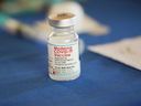 A vial of the Moderna COVID-19 vaccine rests on a table at an inoculation station next to Jackson State University in Jackson, Miss., Tuesday, July 19, 2022.