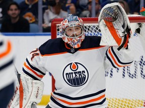 Edmonton Oilers goaltender Stuart Skinner (74) keeps his eyes on the puck during the first period of an NHL hockey game against the Buffalo Sabres non Nov. 12, 2021, in Buffalo, N.Y.